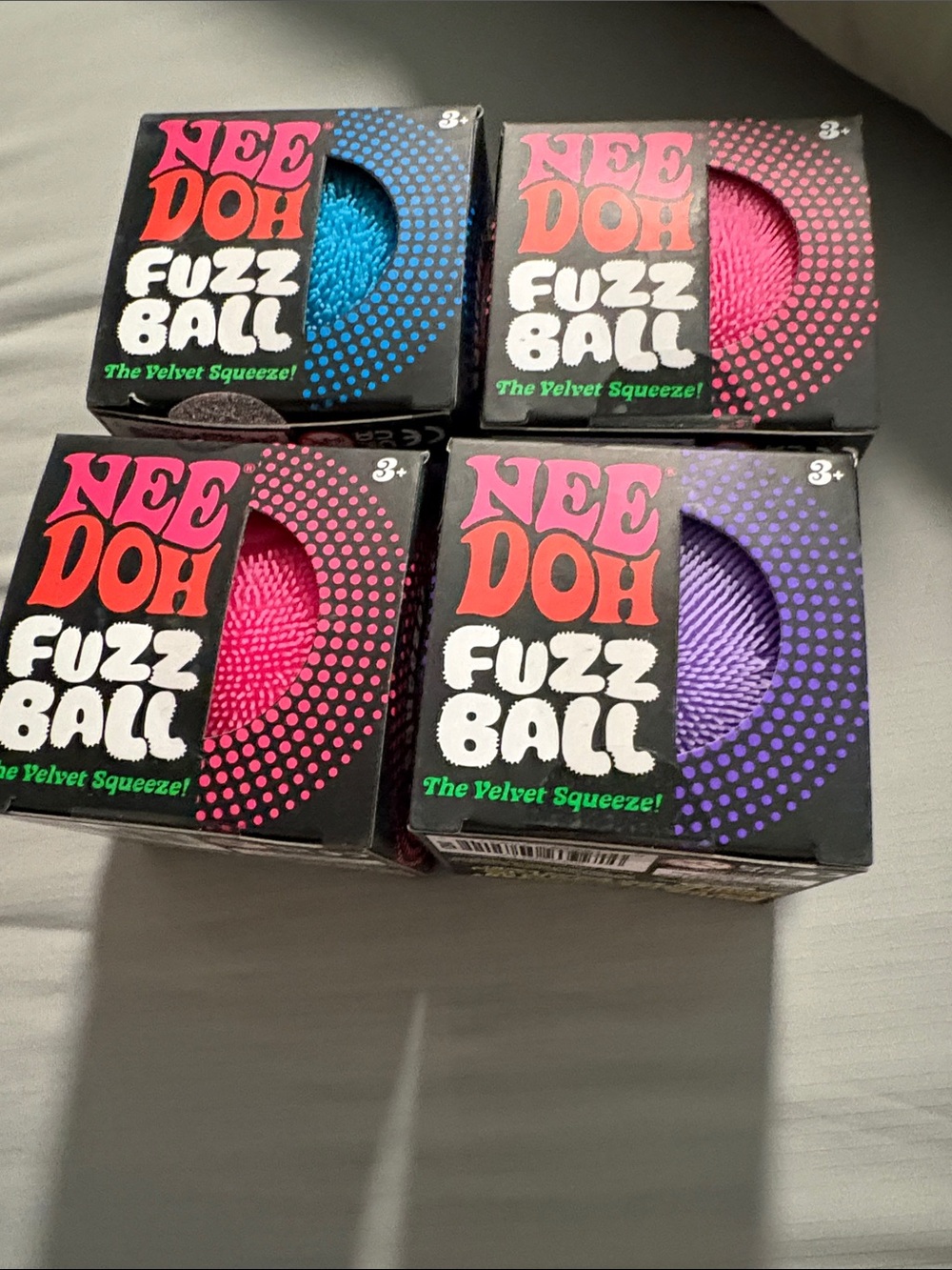 Brand new Needoh in box unopened. Blue  and 2 Pink andPurple Fuzz Balls (4 Pack)